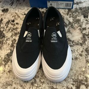 Brand new Adidas slip on sneakers. Size 6 men’s, gender neutral.